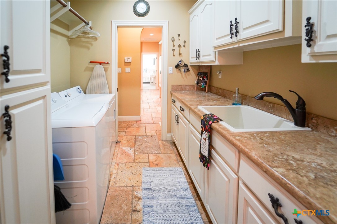 501 Barbara Street Ganado, TX 77962 - Photo 25 of 43 Another view of the functional laundry room with the hallway with cubbies seen in the distance.