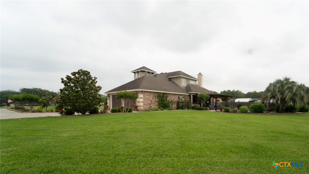 501 Barbara Street Ganado, TX 77962 - Photo 32 of 43 a view of a house with a big yard and large trees