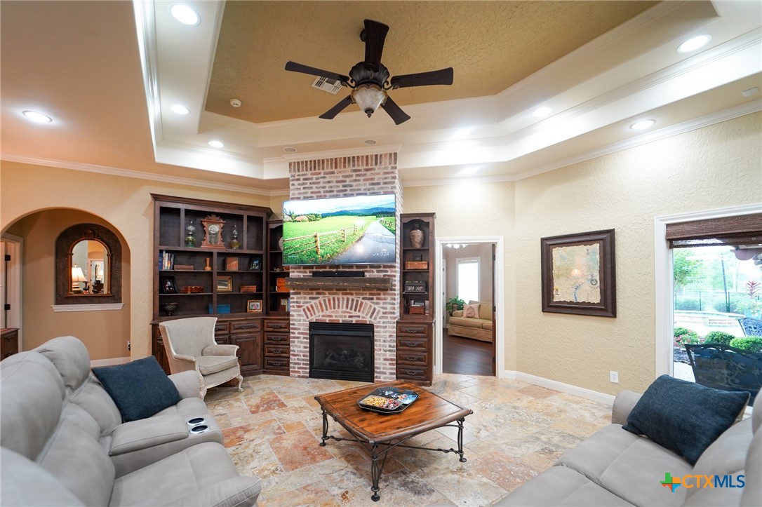 501 Barbara Street Ganado, TX 77962 - Photo 6 of 43 a living room with furniture a fireplace and a flat screen tv