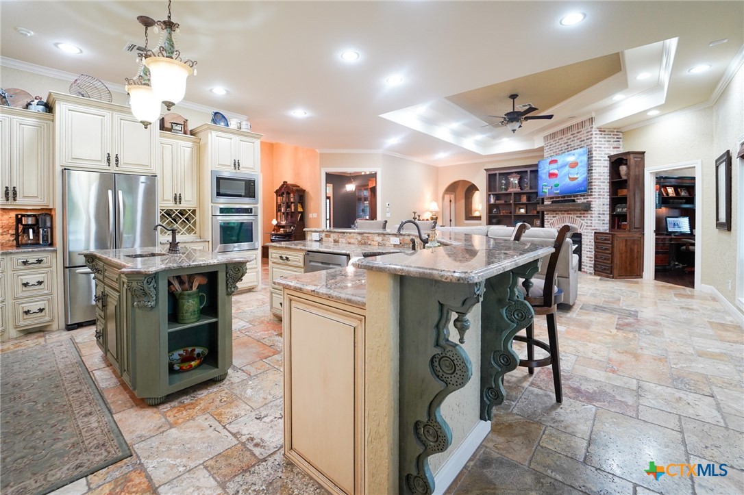 501 Barbara Street Ganado, TX 77962 - Photo 9 of 43 Where will you be in this area? Behind the island prepping, at the bar watching the cook or perhaps catching the game either from the bar or in the living area? Such versatility of this space has a place for everyone!