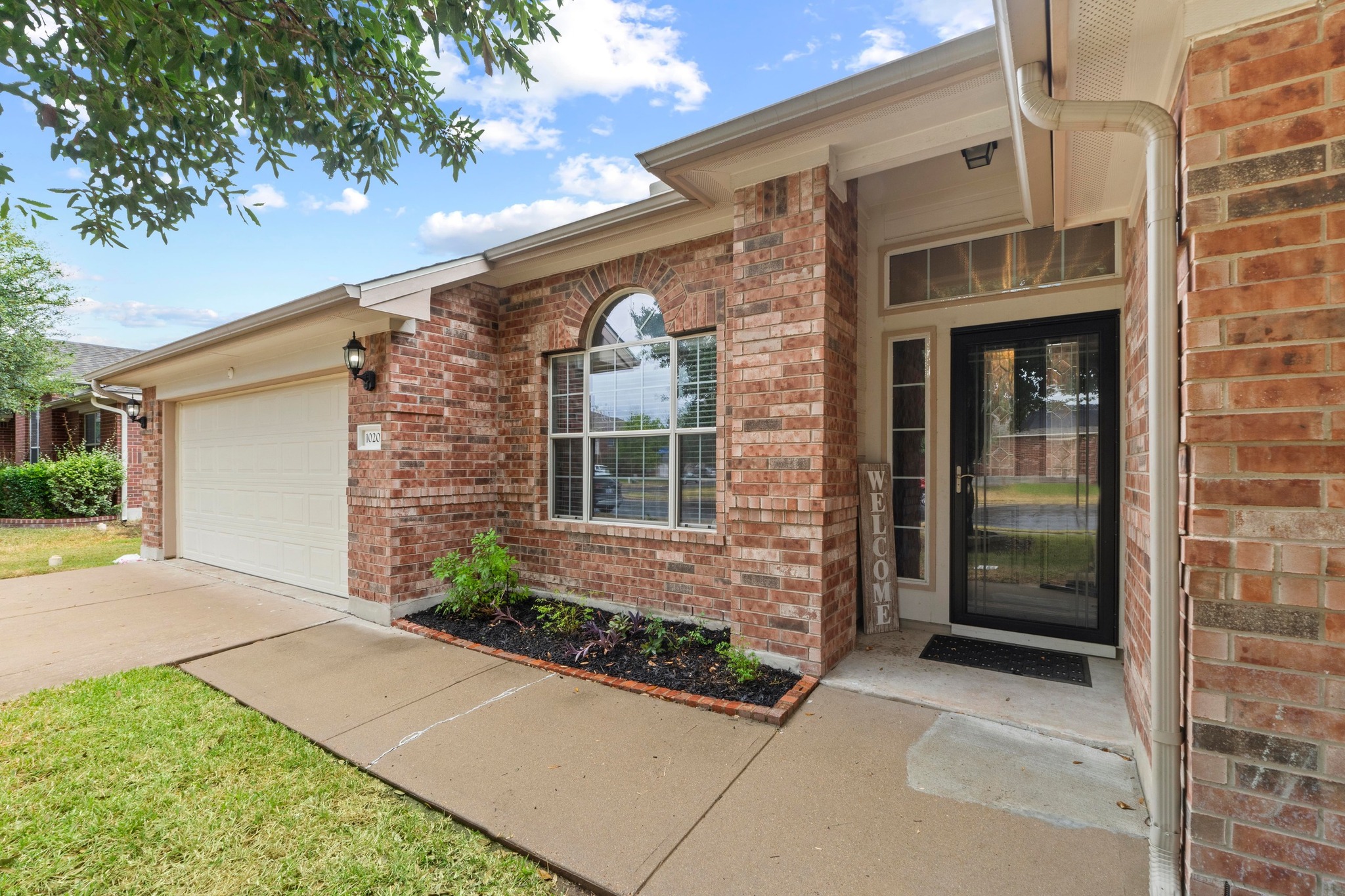 1020 Portchester Castle Path Pflugerville, TX 78660 - Photo 2 of 29 Views of the clean walkway that guides you to the front porch and storm/front door.