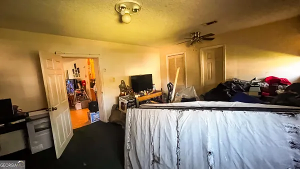 a bathroom with a toilet a sink and shower curtain