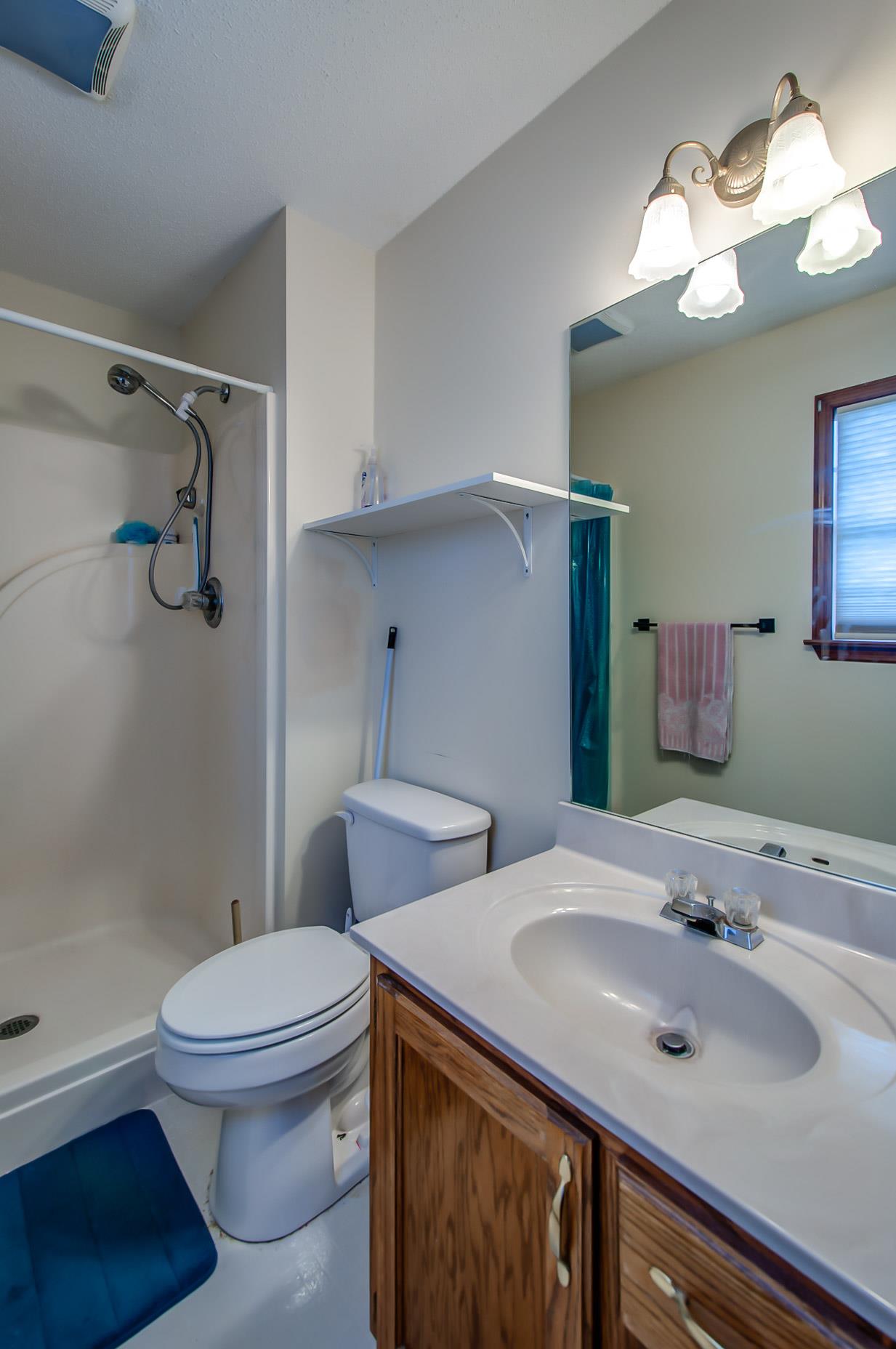 2142 Clara Mathis Road Spring Hill, TN 37174 - Photo 12 of 20 a bathroom with a sink toilet vanity and shower