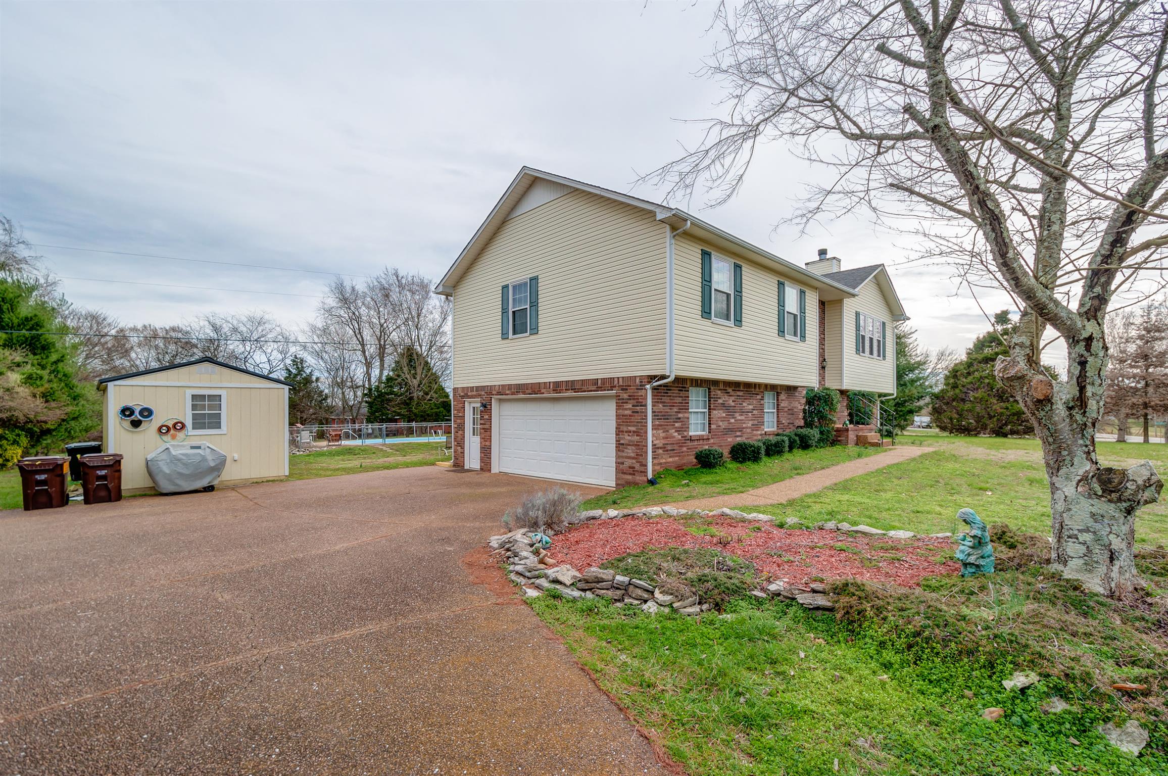 2142 Clara Mathis Road Spring Hill, TN 37174 - Photo 3 of 20 a view of a house with a yard and large tree