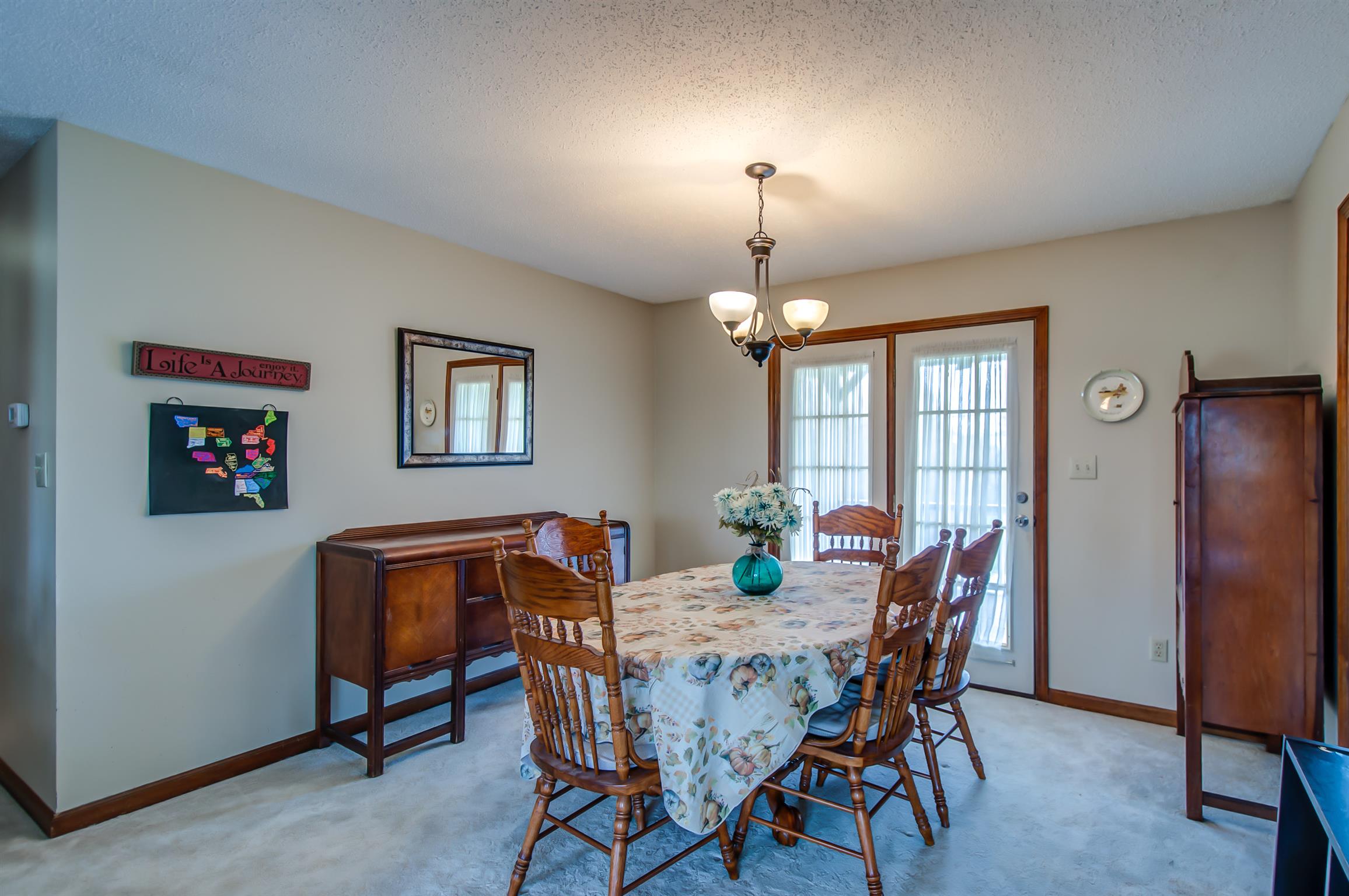 2142 Clara Mathis Road Spring Hill, TN 37174 - Photo 6 of 20 a view of a dining room with furniture and chandelier