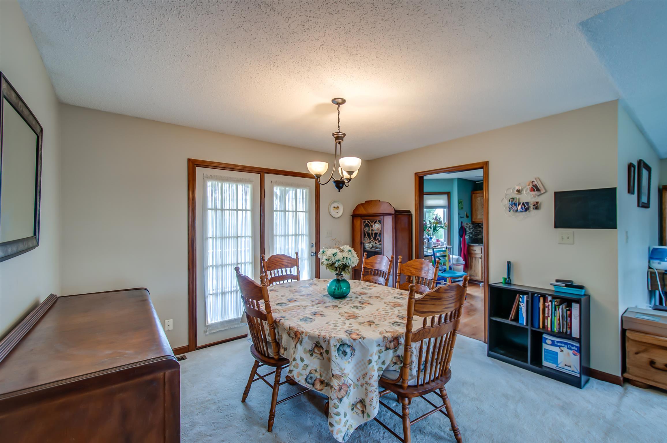 2142 Clara Mathis Road Spring Hill, TN 37174 - Photo 7 of 20 a view of a dining room with furniture and a chandelier