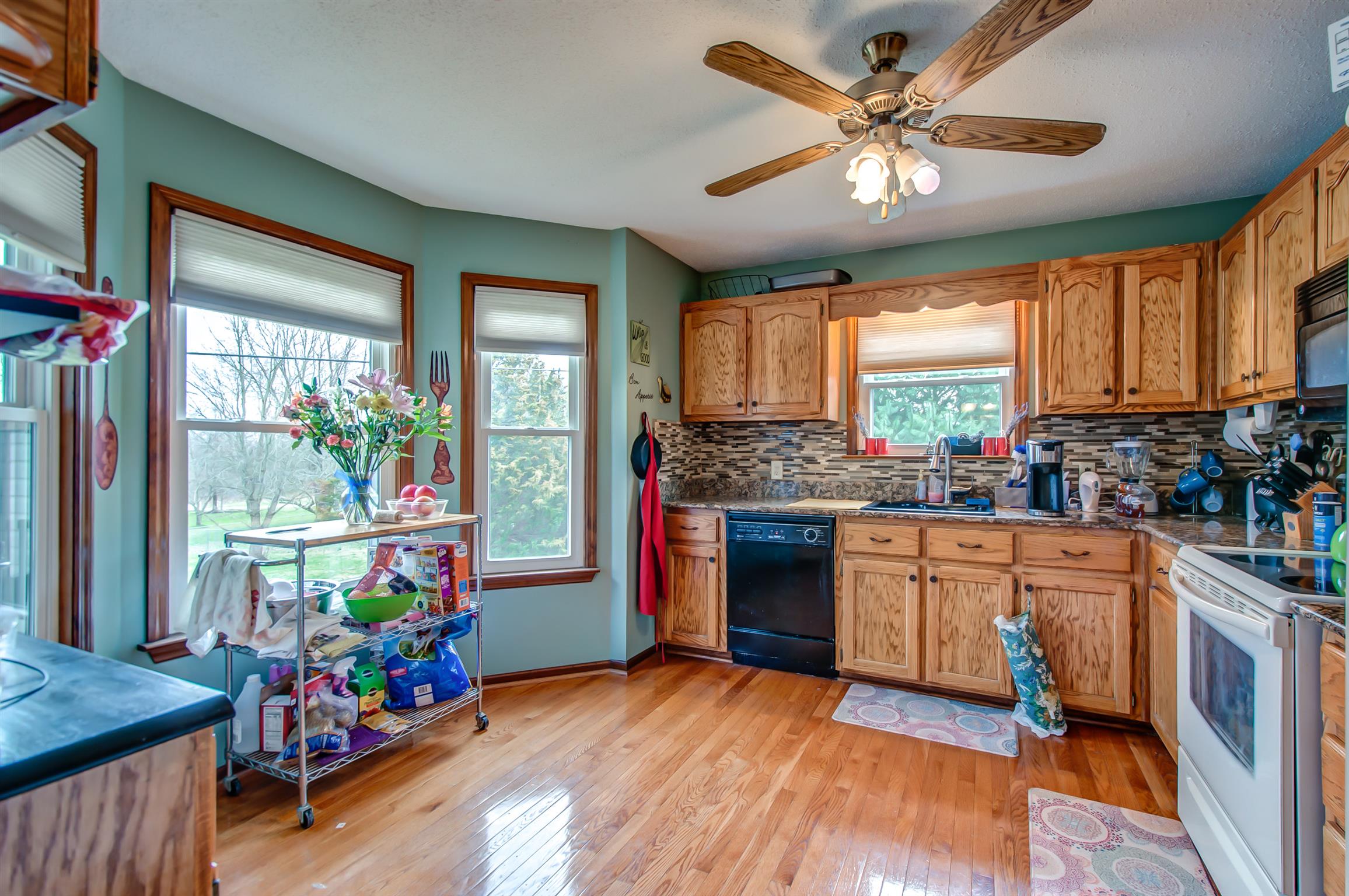 2142 Clara Mathis Road Spring Hill, TN 37174 - Photo 8 of 20 a open kitchen with stainless steel appliances granite countertop a stove a sink dishwasher and a refrigerator with wooden floor