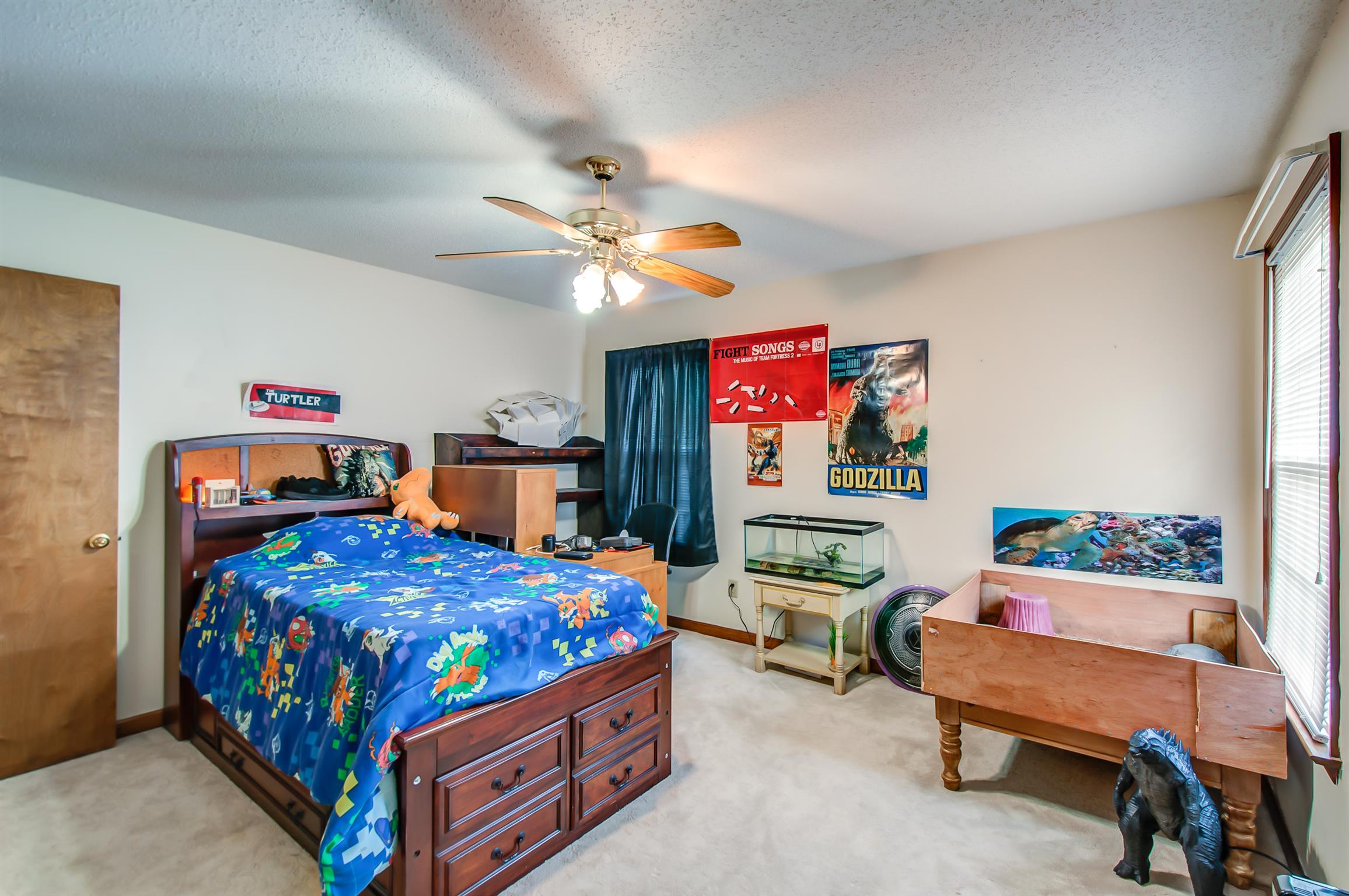 2142 Clara Mathis Road Spring Hill, TN 37174 - Photo 10 of 20 a bedroom with a bed a couch and a chandelier