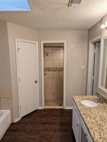 a bathroom with a granite countertop sink a toilet and a mirror