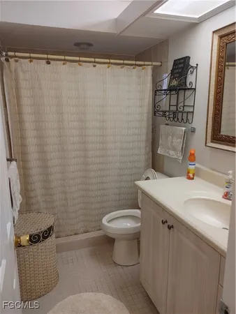 a bedroom with a bed and a flat tv screen on dresser