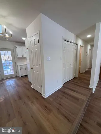a view of a livingroom with wooden floor and stairs