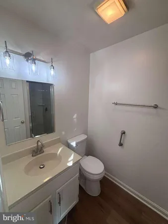 a bathroom with a sink mirror and toilet