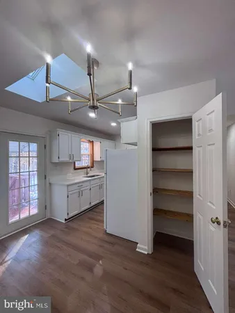 a kitchen with a refrigerator and a stove top oven