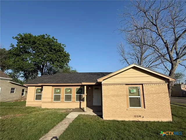 a front view of a house with a yard