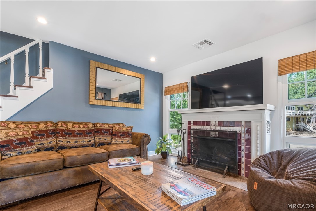 195 Elgin Road Big Bear Lake, CA 92315 - Photo 6 of 45 a living room with furniture a flat screen tv and a fireplace