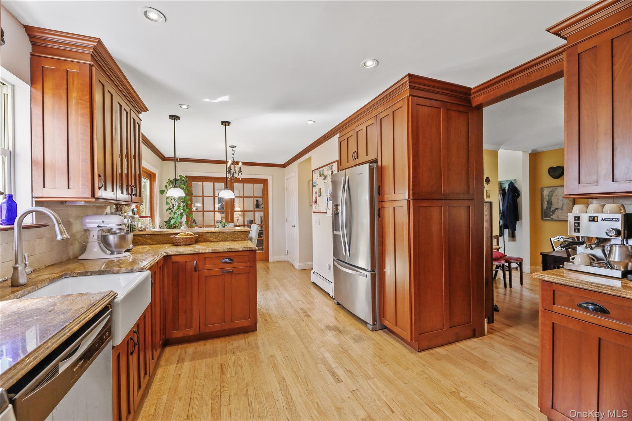 17 Jennifers Path Westhampton Beach, NY 11978 - Photo 13 of 41 a kitchen with stainless steel appliances granite countertop a refrigerator a sink dishwasher a stove and a dining table with wooden floor