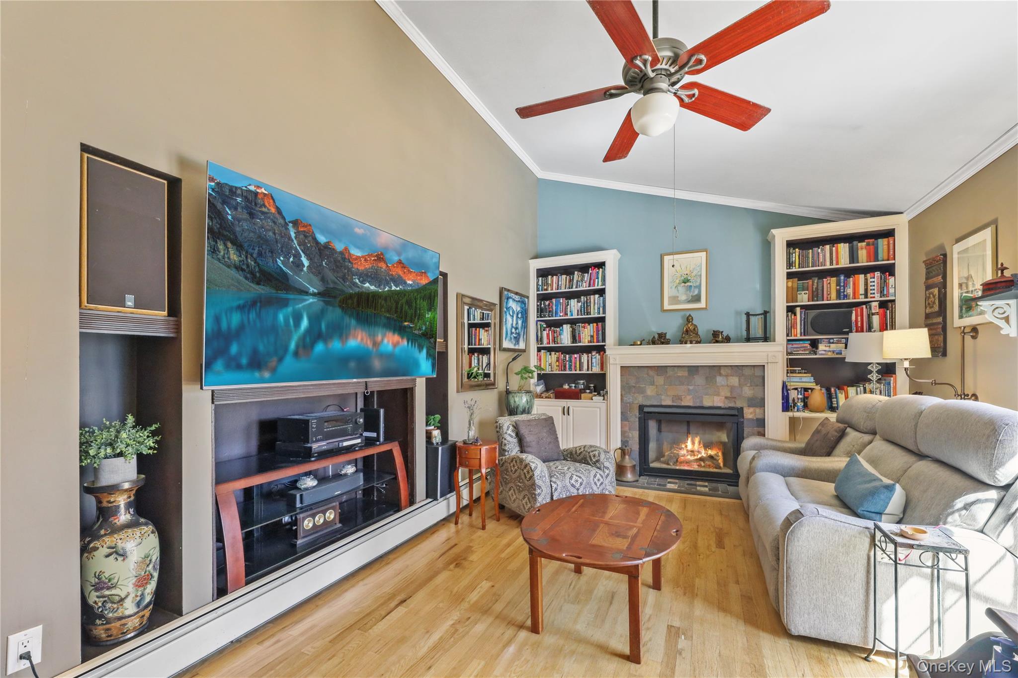 17 Jennifers Path Westhampton Beach, NY 11978 - Photo 15 of 41 a living room with furniture a flat screen tv and a fireplace