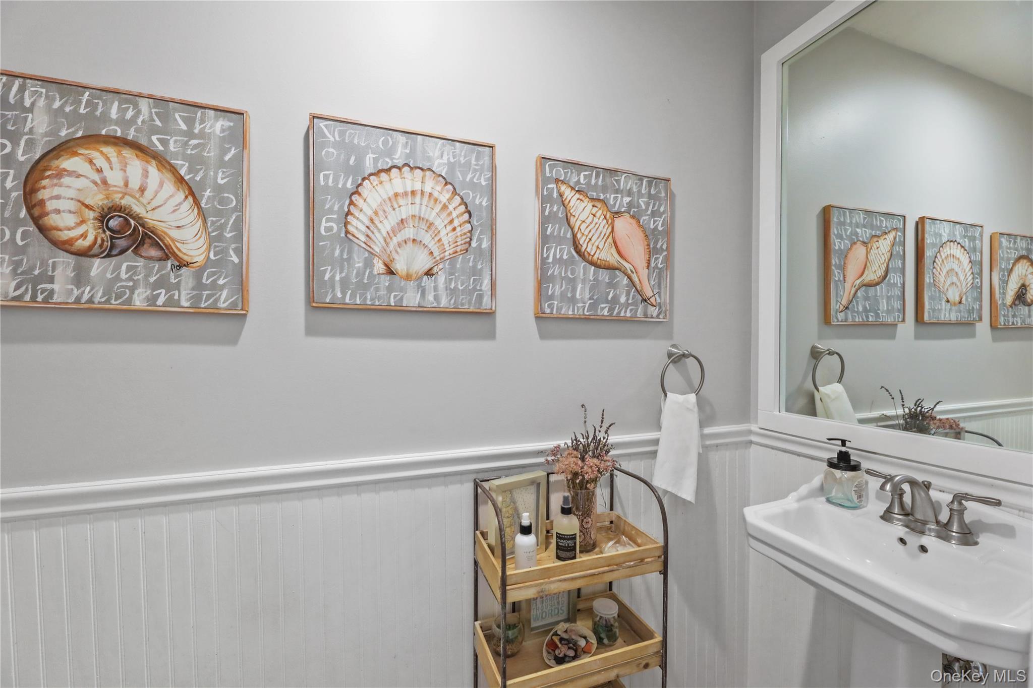 17 Jennifers Path Westhampton Beach, NY 11978 - Photo 19 of 41 a bathroom with double vanity sink and a two mirror