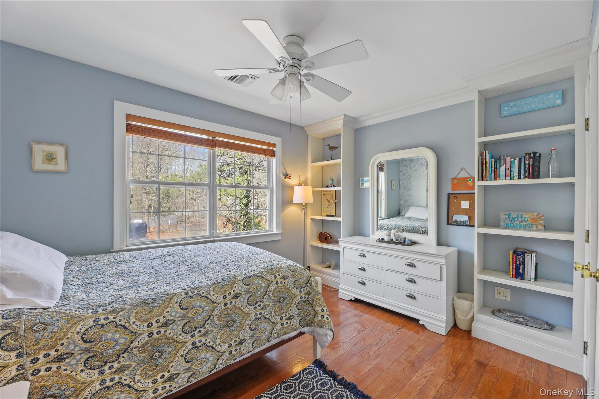 17 Jennifers Path Westhampton Beach, NY 11978 - Photo 25 of 41 a bedroom with a bed and a bookshelf