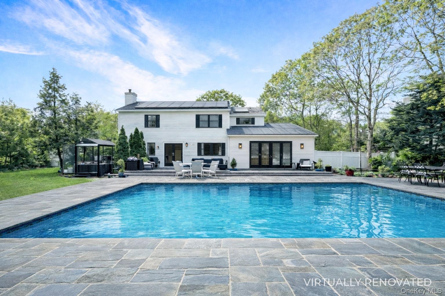 17 Jennifers Path Westhampton Beach, NY 11978 - Photo 3 of 41 a swimming pool view with a seating space and a garden view
