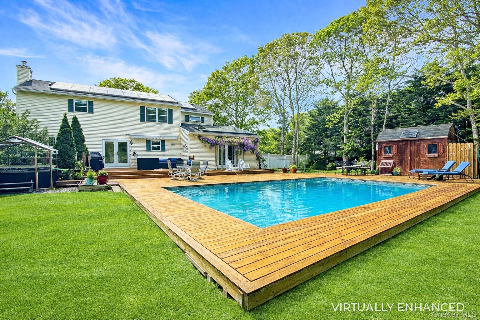 17 Jennifers Path Westhampton Beach, NY 11978 - Photo 33 of 41 a view of an house with swimming pool and a yard