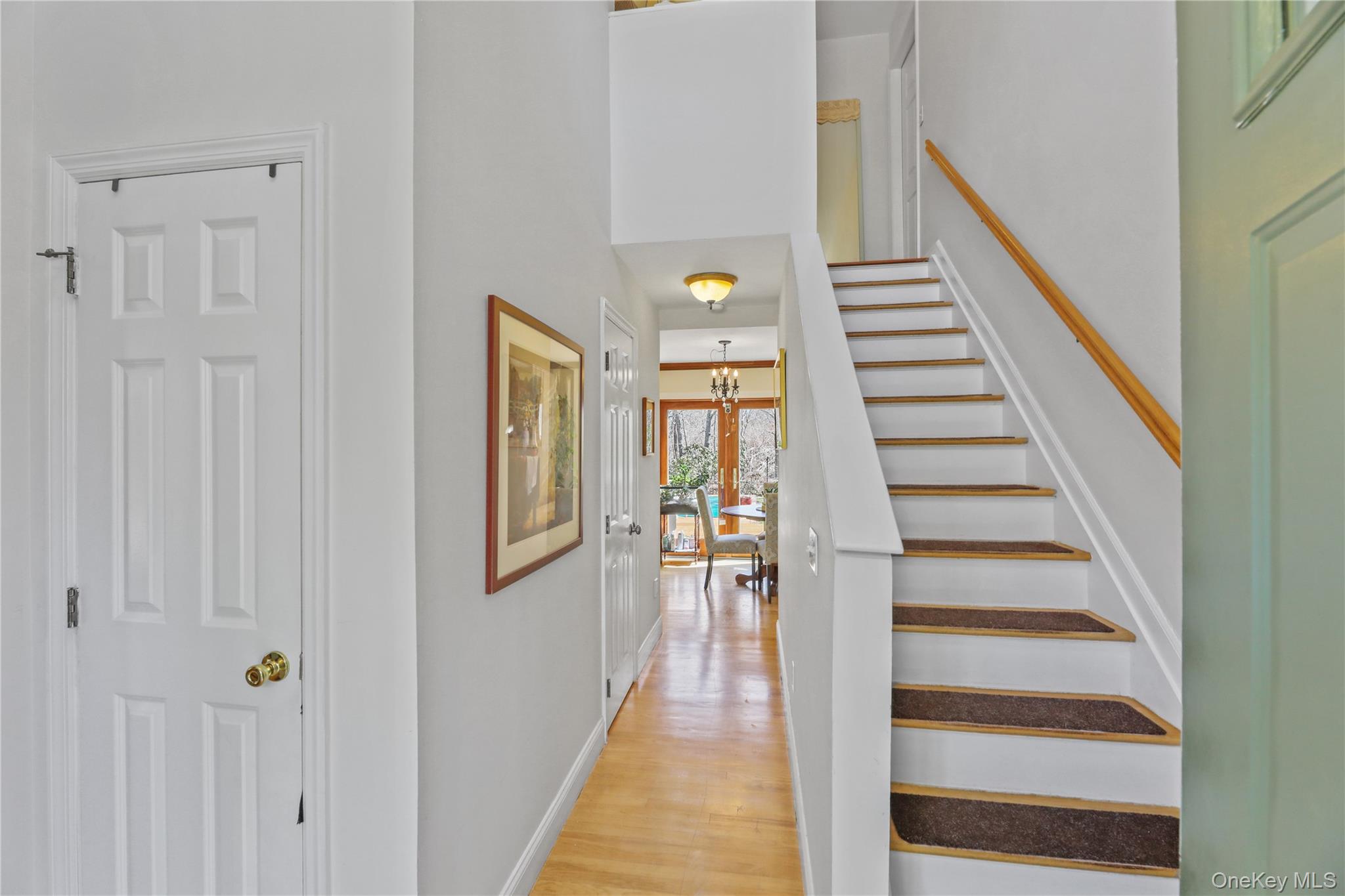 17 Jennifers Path Westhampton Beach, NY 11978 - Photo 7 of 41 a view of a hallway with wooden floor and staircase