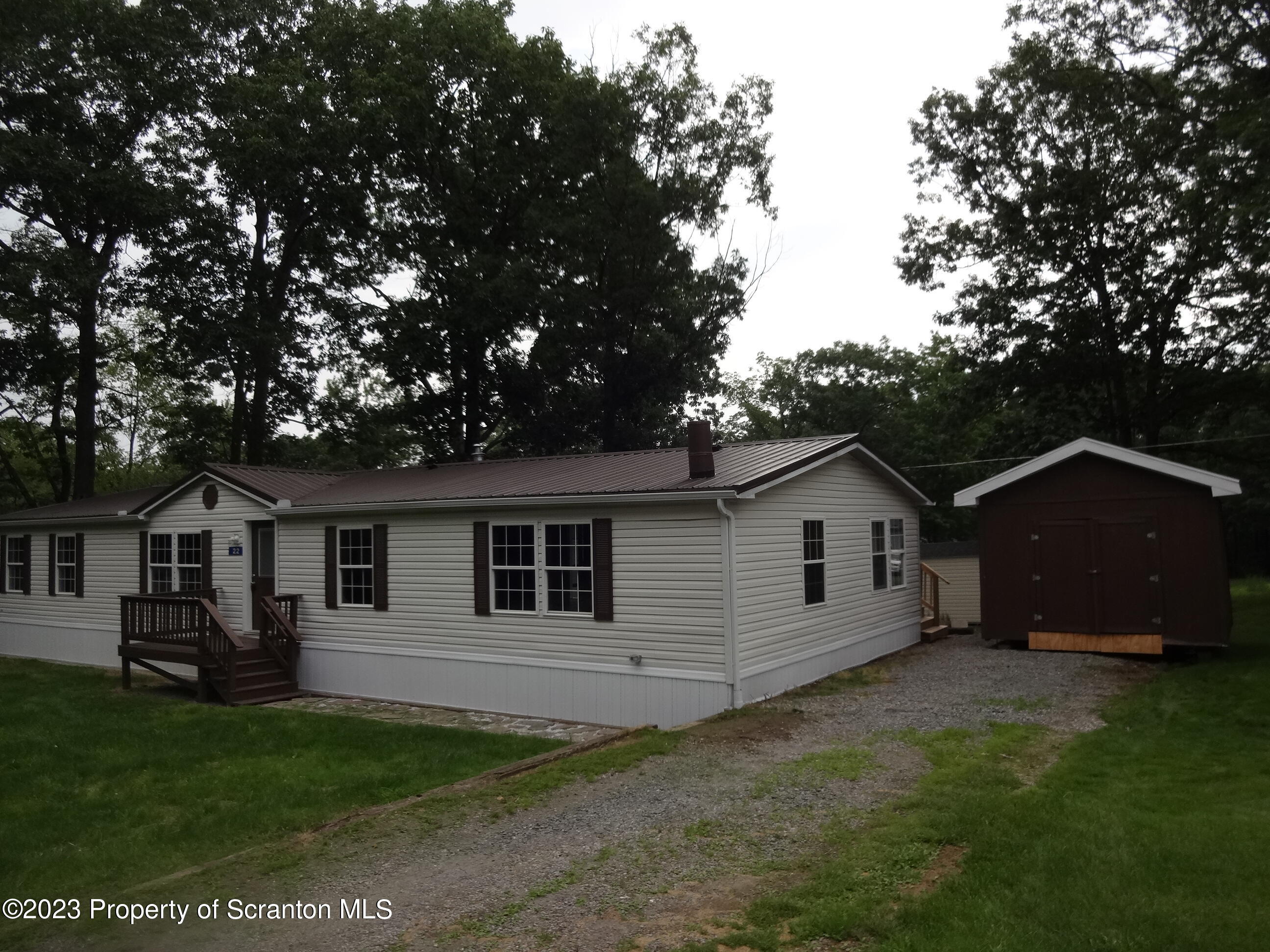 22 Hi View Terrace. Lake Ariel, PA 18436 - Photo 27 of 28 a view of a yard in front of a house with plants and large tree