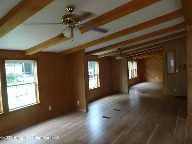 a view of livingroom with hardwood floor and a ceiling fan