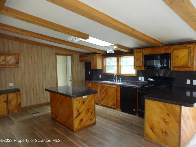 a kitchen with granite countertop a stove and cabinets