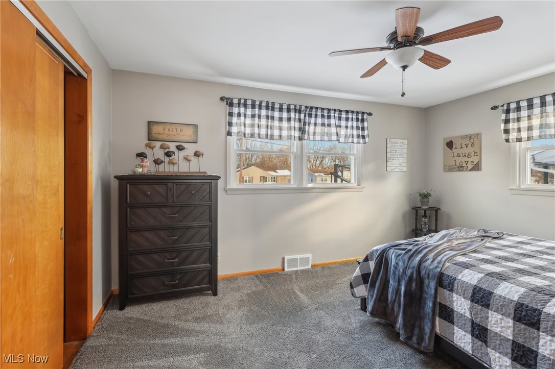 2634 Brunswick Road Youngstown, OH 44511 - Photo 21 of 50 Carpeted bedroom featuring multiple windows, ceiling fan, and a closet