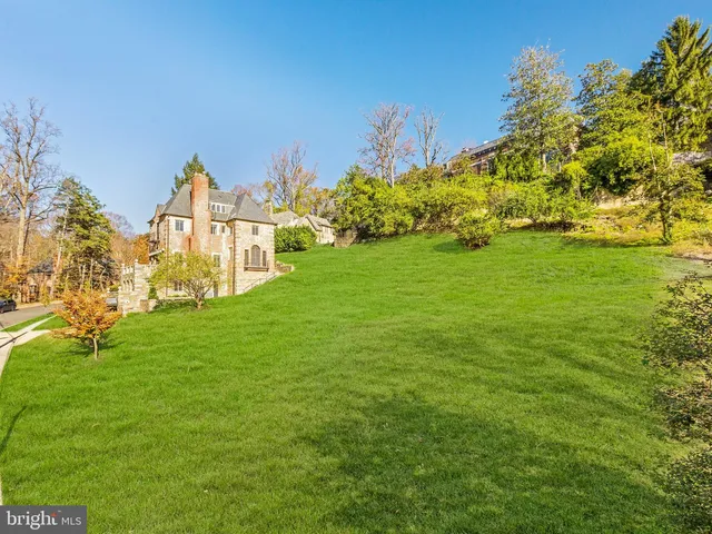 a view of a garden with a building in the background