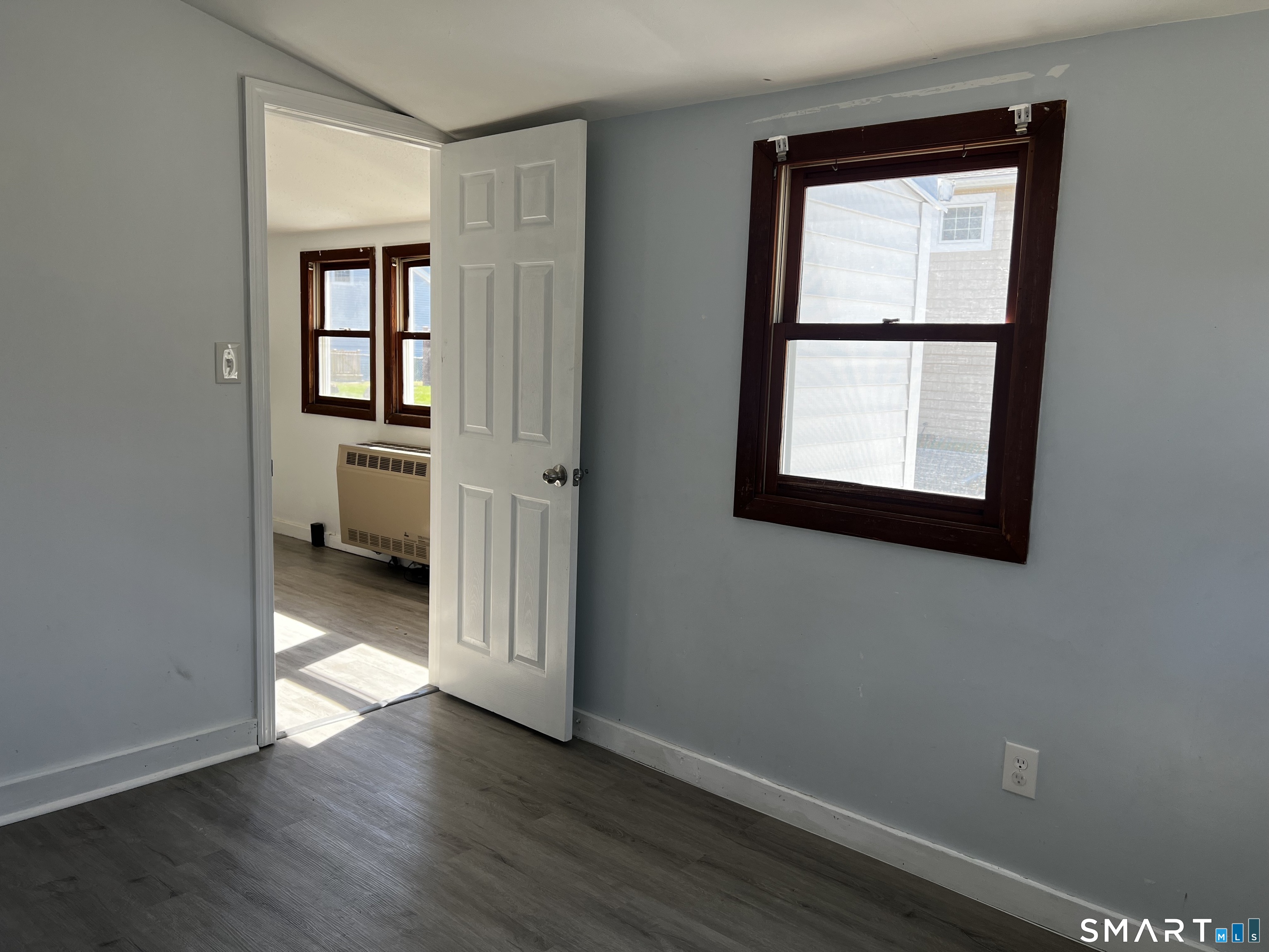 40 Portland Avenue, Unit 1 Old Lyme, CT 06371 - Photo 11 of 39 an empty room with wooden floor and a window