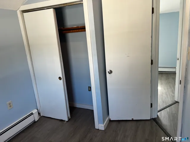 a view of walk in closet with wooden floor