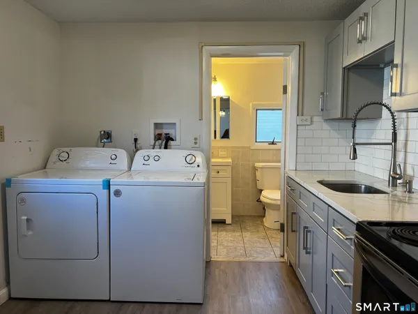 a utility room with sink dryer and washer