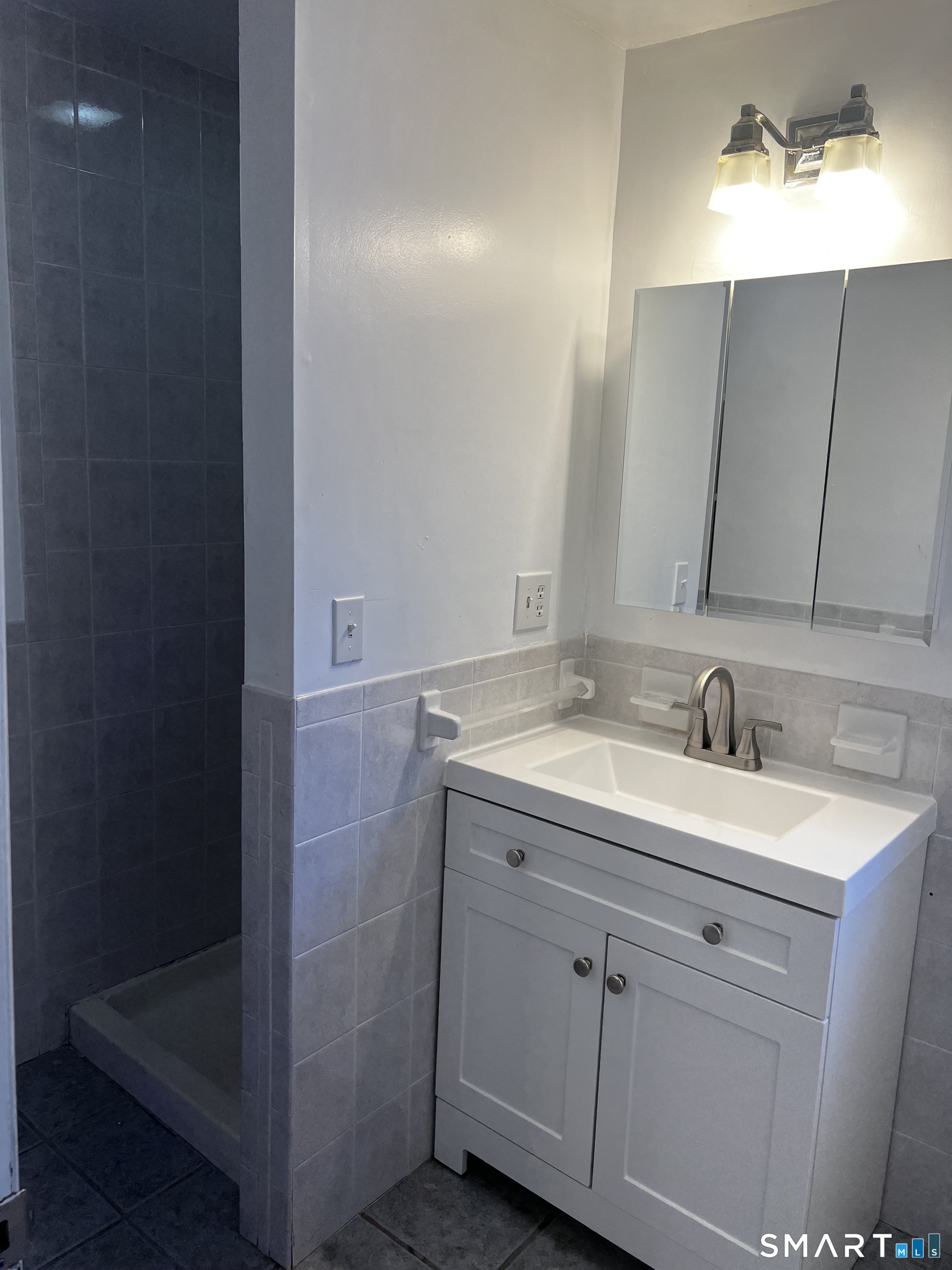 40 Portland Avenue, Unit 1 Old Lyme, CT 06371 - Photo 38 of 39 a bathroom with a granite countertop sink and a mirror