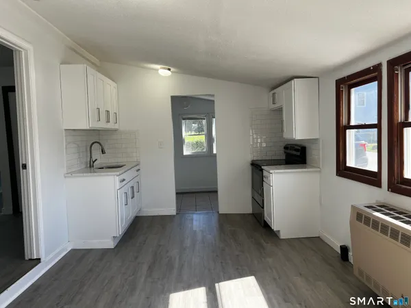 a kitchen with a refrigerator and a stove top oven