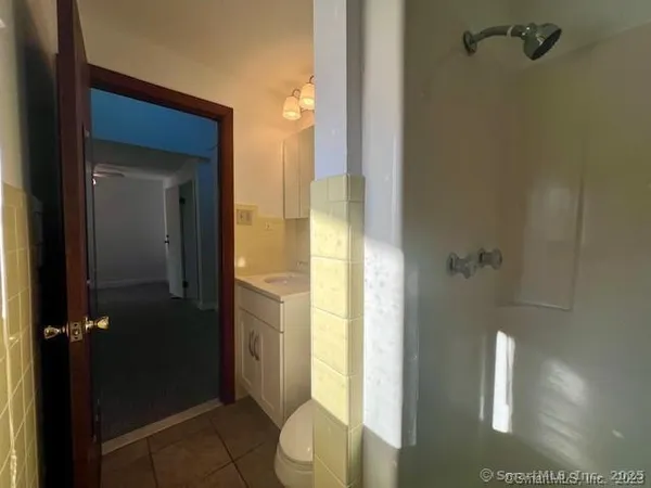 a bathroom with a granite countertop shower
