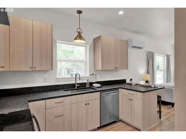 a kitchen with granite countertop white cabinets white appliances and sink