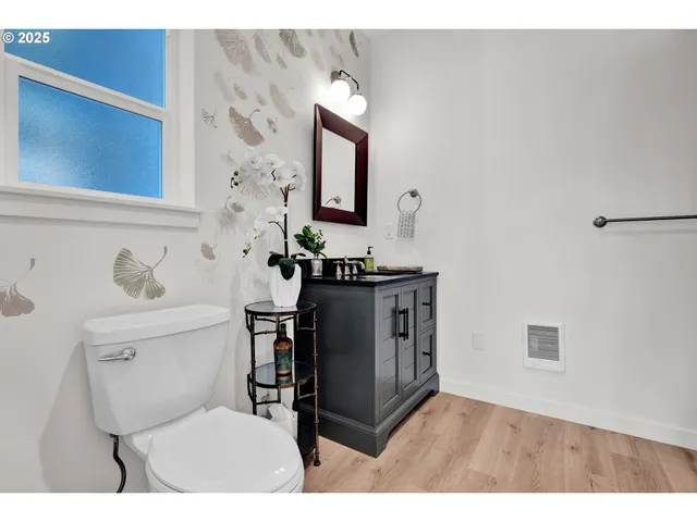 a bathroom with a toilet a sink and mirror