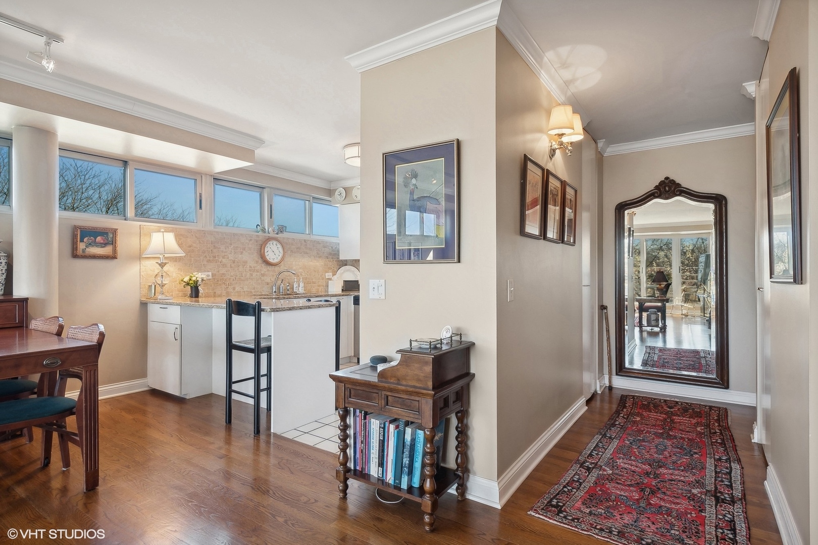 2555 Gross Point Road, Unit 412 Evanston, IL 60201 - Photo 3 of 26 a workspace with furniture wooden floor and a rug