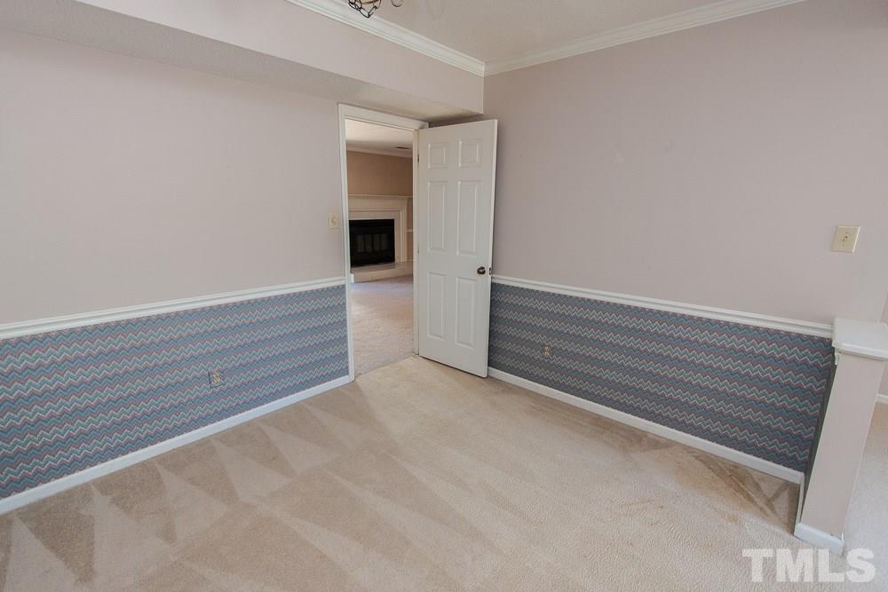 1535 Edgeside Court Raleigh, NC 27609 - Photo 11 of 20 a view of an empty room with wooden floor and a window