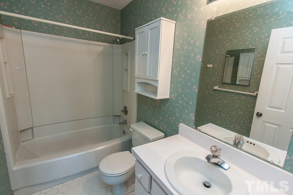 1535 Edgeside Court Raleigh, NC 27609 - Photo 16 of 20 a bathroom with a sink toilet and shower