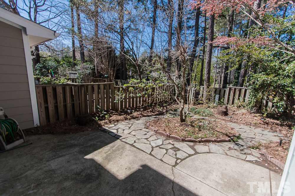 1535 Edgeside Court Raleigh, NC 27609 - Photo 3 of 20 a view of backyard with wooden fence and trees