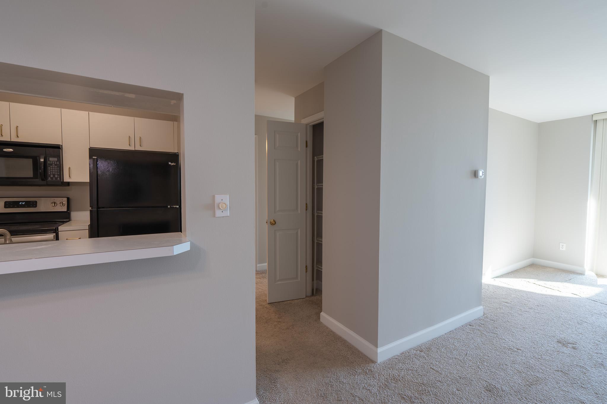 100 Harborview Drive, Unit 1208 Baltimore, MD 21230 - Photo 11 of 36 a view of a kitchen with an empty space and a fireplace