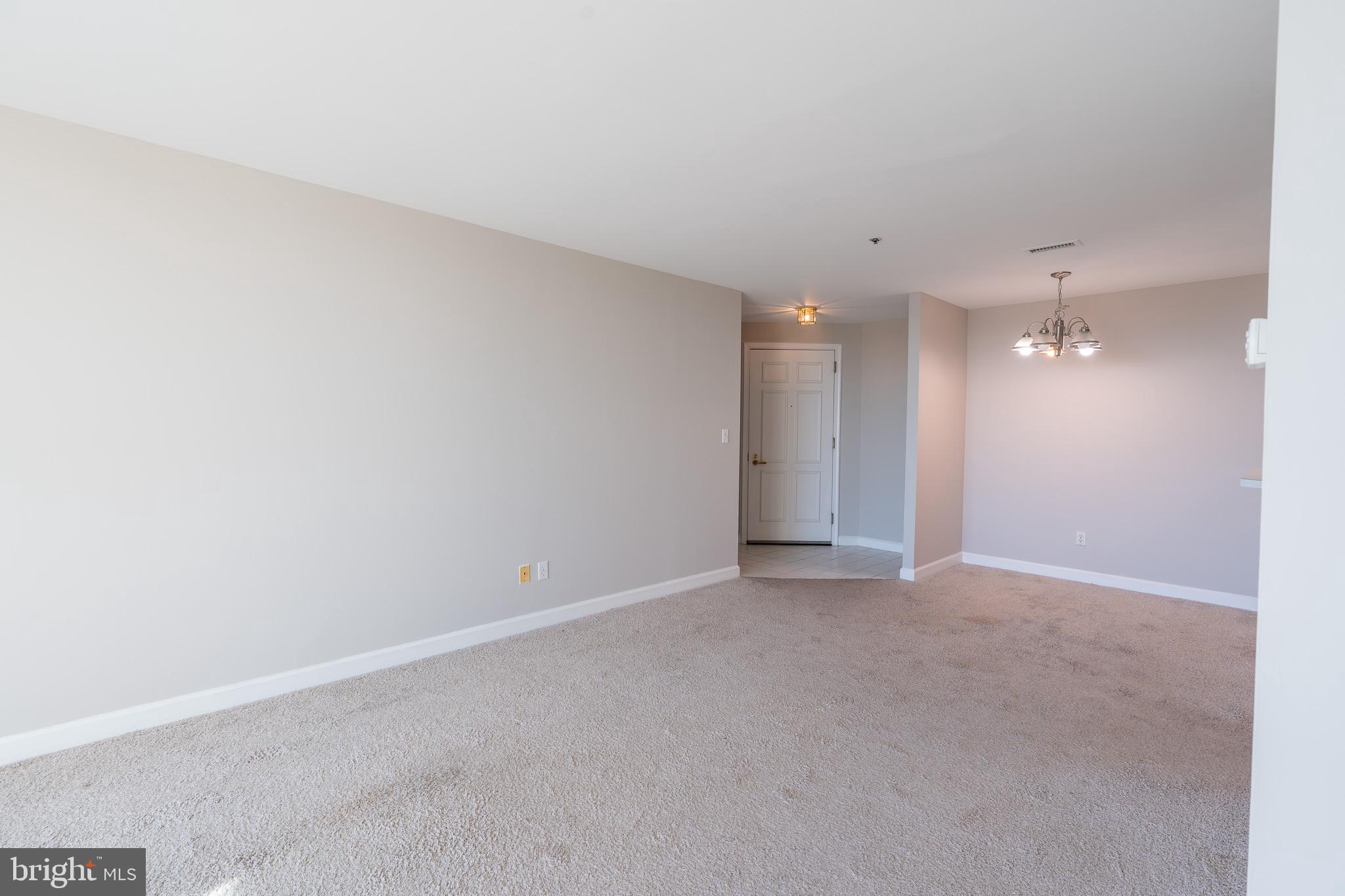 100 Harborview Drive, Unit 1208 Baltimore, MD 21230 - Photo 14 of 36 a view of an empty room with a kitchen