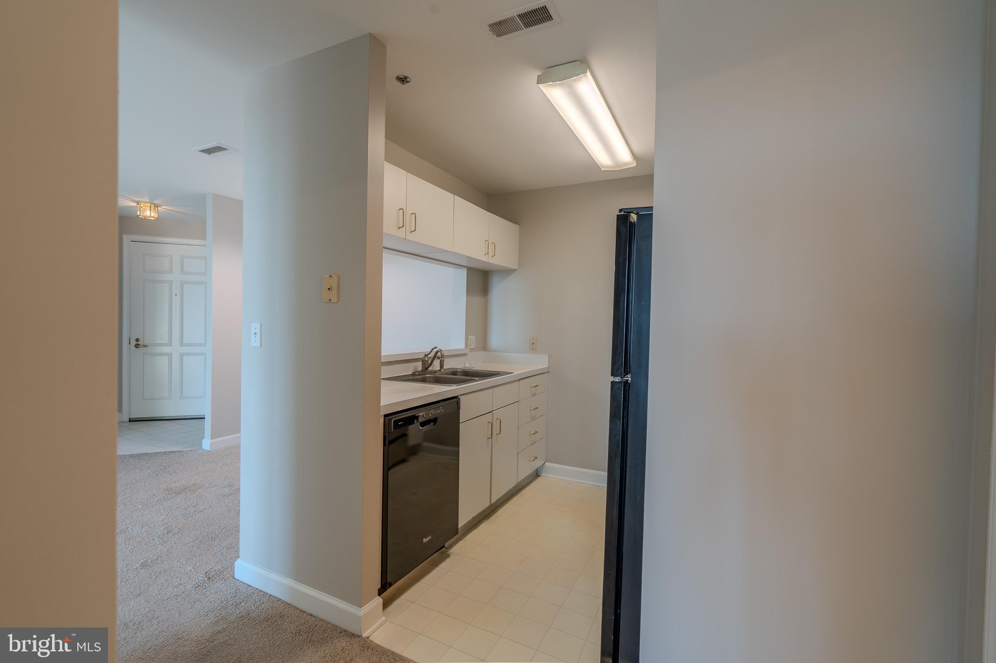 100 Harborview Drive, Unit 1208 Baltimore, MD 21230 - Photo 16 of 36 a view of a kitchen from the hallway