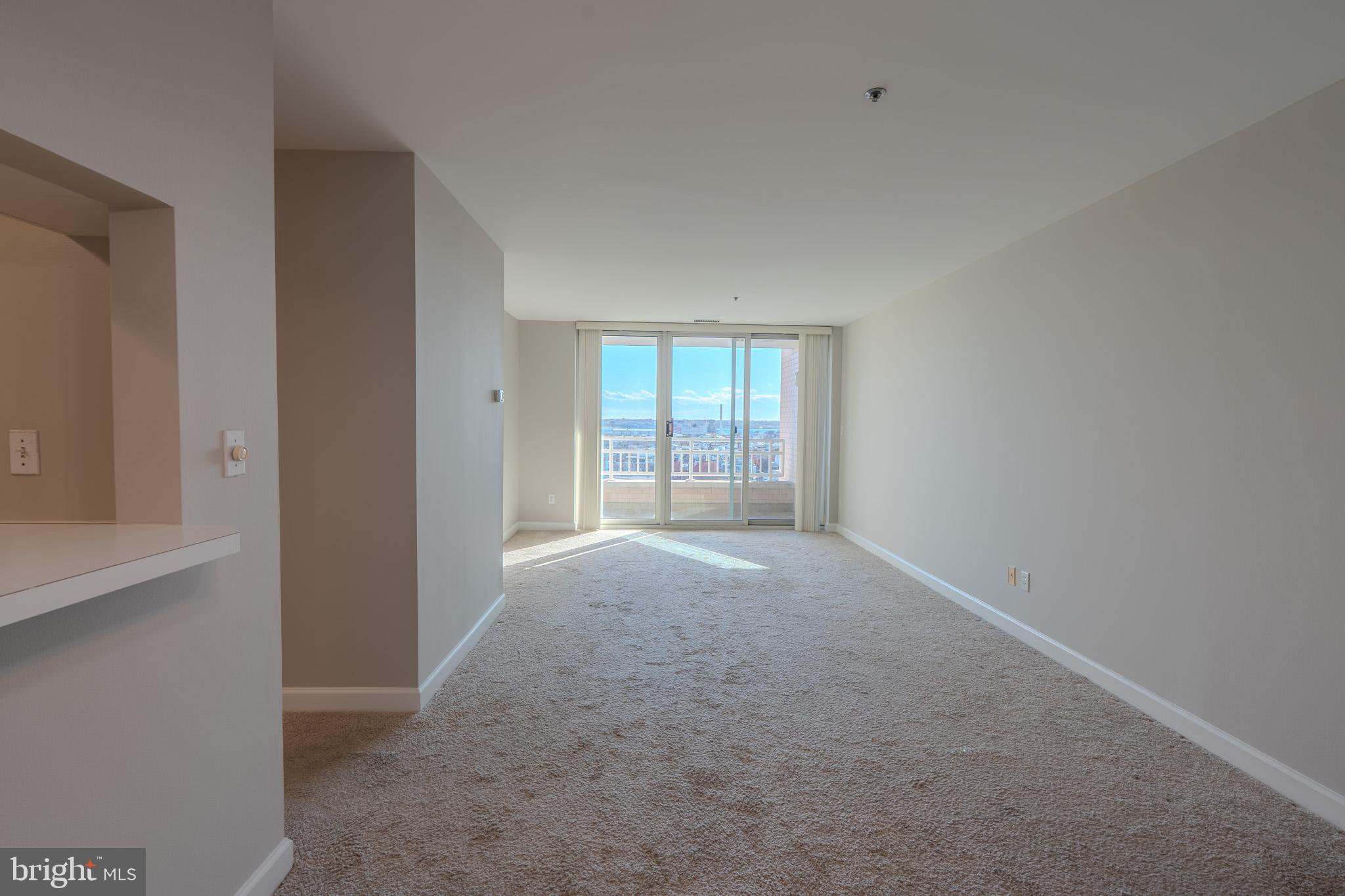 100 Harborview Drive, Unit 1208 Baltimore, MD 21230 - Photo 19 of 36 an empty room with windows