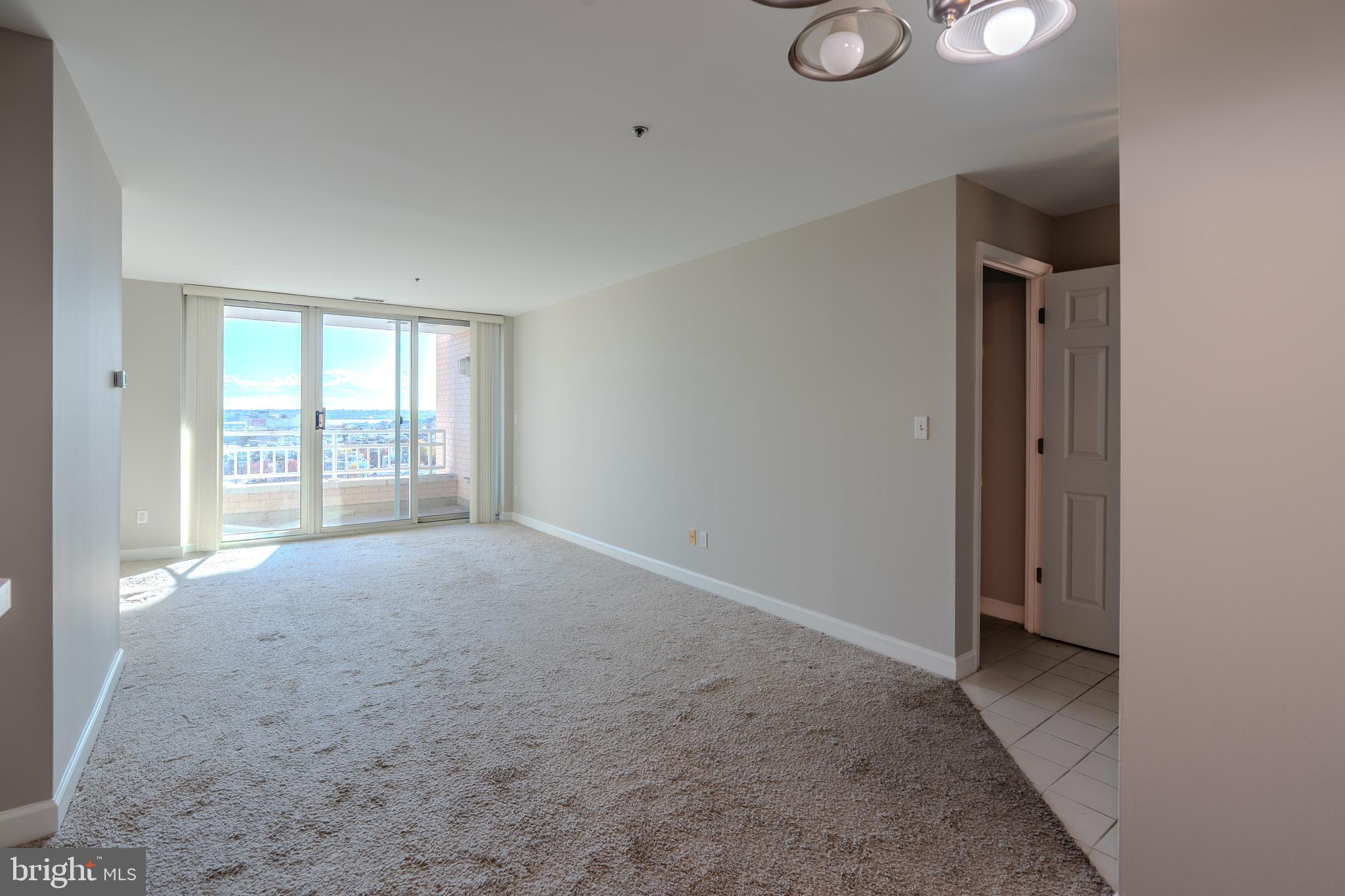 100 Harborview Drive, Unit 1208 Baltimore, MD 21230 - Photo 8 of 36 an empty room with windows