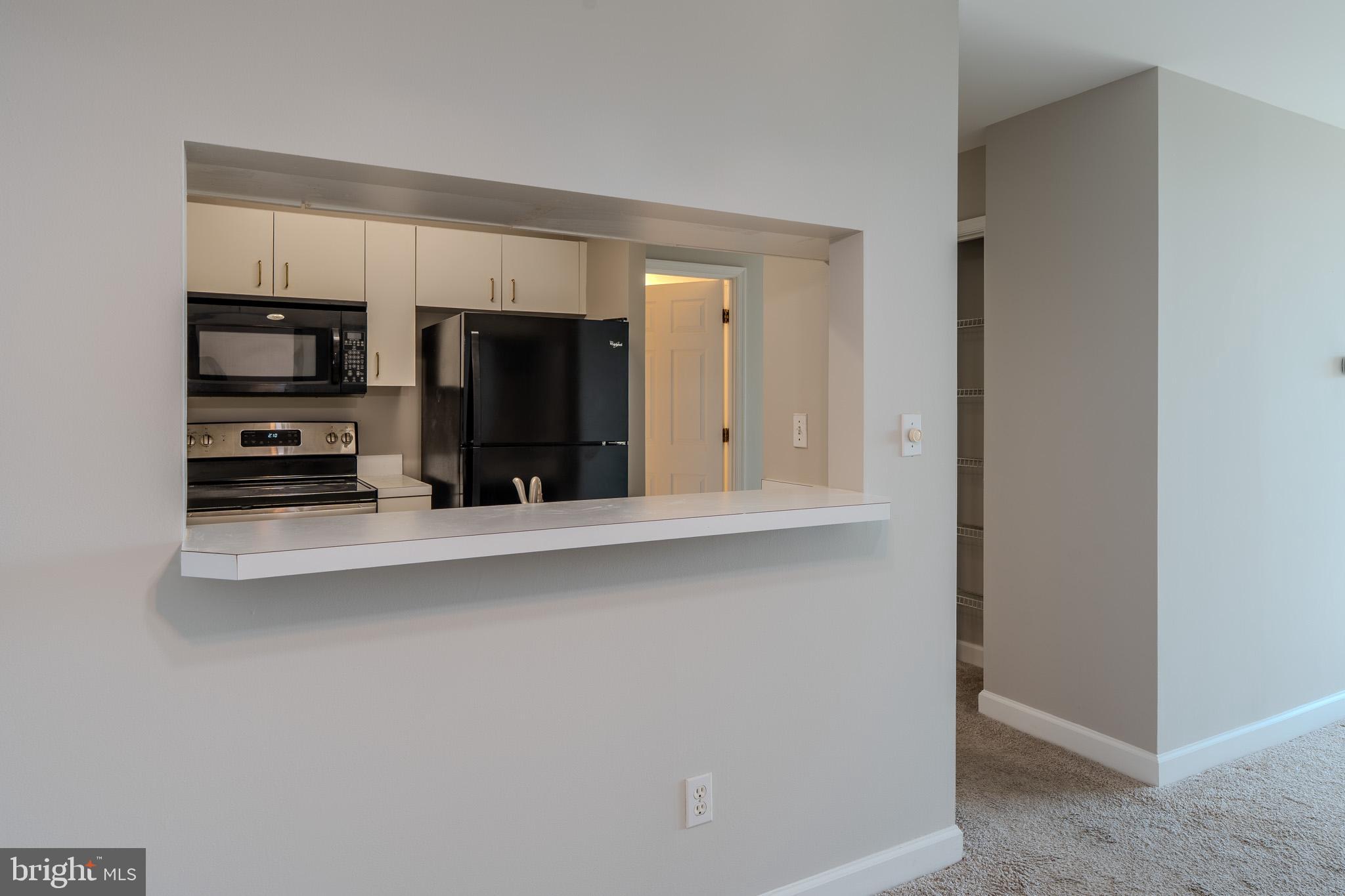 100 Harborview Drive, Unit 1208 Baltimore, MD 21230 - Photo 9 of 36 a kitchen with stainless steel appliances a refrigerator and cabinets