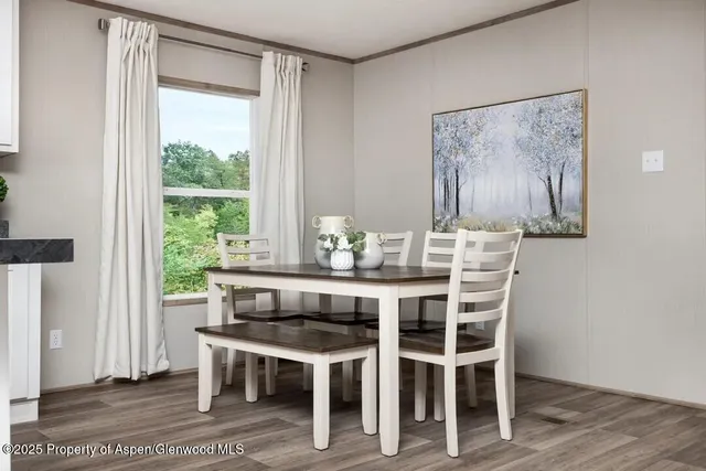 a dining room with furniture a rug and wooden floor